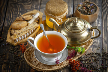 Sweet, hot tea with dessert, on an old background.