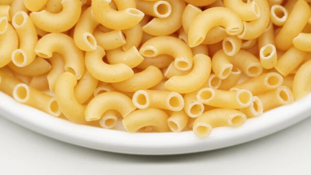 Background of Uncooked Noodles that Slowly Rotating. Texture of Dry Vermicelli Turning Around. Raw Pasta. Bunch of raw pasta spins in a circle