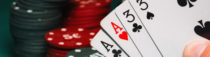 cards with two pairs in the hands of the player in a game of poker on the background of gaming...