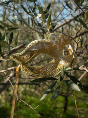 Venetian golden mask on the tree