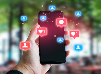 man using smartphone with social media icons pop up, social media, social network concept, outdoor background