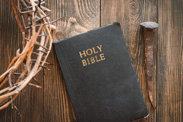 Crown thorns and holy bible or book on a wood background, copy space. Concept for faith,...