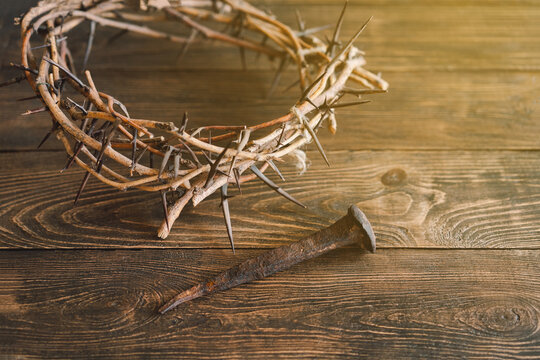 Jesus Crown Thorns and nails and cross on a wood background. Crucifixion Of Jesus Christ. Passion Of Jesus Christ. Concept for faith, spirituality and religion. Easter Day