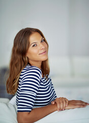 Fototapeta premium What have you got planned for the weekend. Cropped portrait of an attractive young woman sitting on the sofa at home.