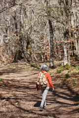 Woman walking in the woods. Healthy lifestyle. Natural environment