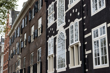 Fototapeta na wymiar Row of Beautiful Old Historical Buildings in the De Wallen Neighborhood of Amsterdam