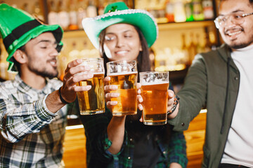 Indian friends celebrate St. Patrick's Day in a pub