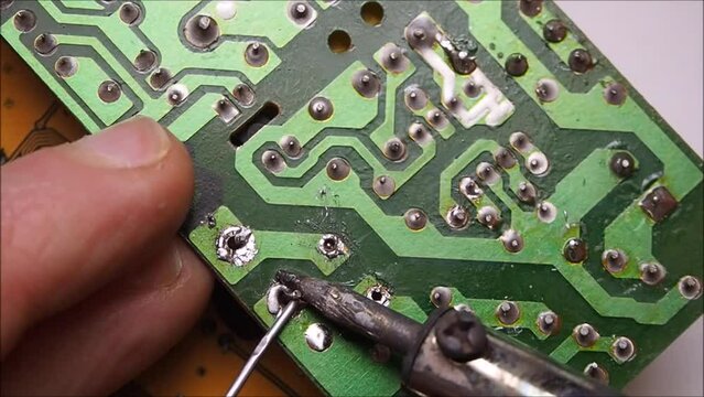 Soldering on electronic circuit board.