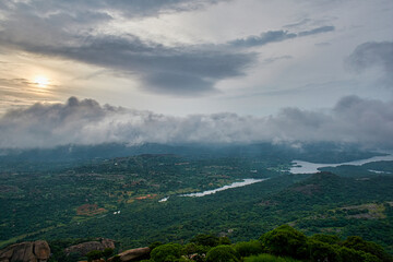 Fototapeta premium Landscape view of a mountain with clouds and river in the morning
