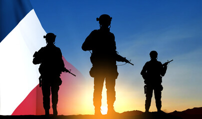 Fototapeta na wymiar Silhouettes of French soldiers on background of sunset and French flag. Concept - Armed Forces. EPS10 vector