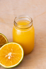 Fototapeta na wymiar Orange juice in glass jar with fresh fruit