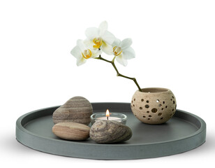 floral home decor with white orchid, candle and stones on ceramic plate isolated on transparent...