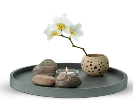 floral home decor with white orchid, candle and stones on ceramic plate isolated on transparent background, creative design concept for wellness at home