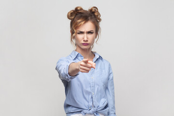 You are guilty. Woman blaming someone, pointing directly at camera, making serious face.