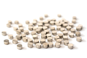 Exhausted or dead hearing aid button batteries, hazardous waste, isolated on white background. Selective focus.