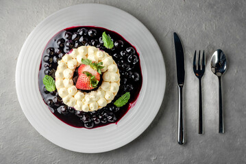 piece of sweet dessert on small dish plate for serve like chocolate strawberry cheesecake custard waffle and ice cream with berries on white mulberry paper.