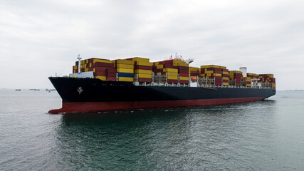 Fototapeta premium cargo container ship sailing in sea to import export goods and distributing products to dealer and consumers