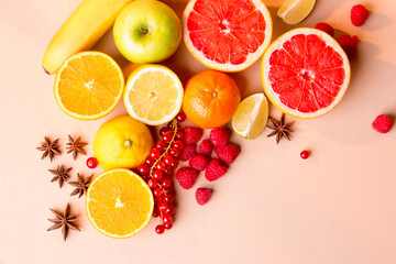 Top view fruits, banana, lemon, orange, grapefruit, apple, berries.