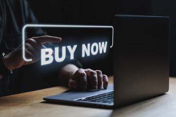 Man pointing on buy now icon shopping cart icon. Online shopping e-commerce concept. Buy online