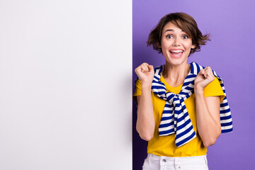 Photo of shocked surprised glad woman wear stylish striped clothes presenting empty space isolated on purple color background