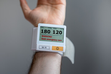Blood pressure monitor indicates high values which are in the category 'hypertensive crisis'.