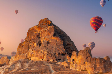 Landscape Ruins of an ancient city in rock Cappadocia with set colorful hot air balloon fly in sky...