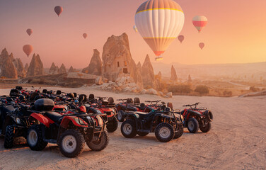 ATV trip quad bike in Cappadocia with set colorful hot air balloon fly in sky with sunset. Concept tourist travel Goreme Turkey © Parilov