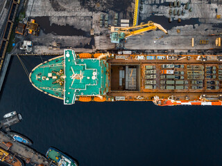 Aerial top view cargo ship with military equipment for transportation humanitarian aid, army forces for war.