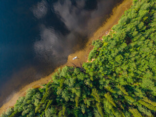 Woman rowing oar on sup board blue sea water. Aerial top view paddleboard