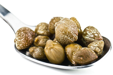 Delicious capers in silver spoon on white background