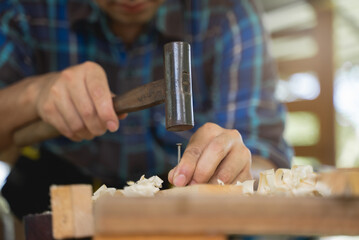 worker using a hammer in woodwork construction