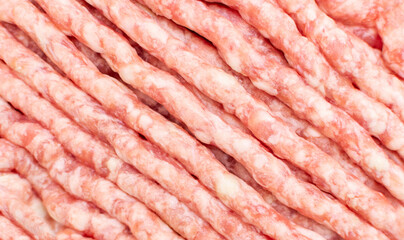 Raw fresh ground pork and beef minced meat, uncooked mincemeat close-up, top view. Ingredient for cooking burger, food.