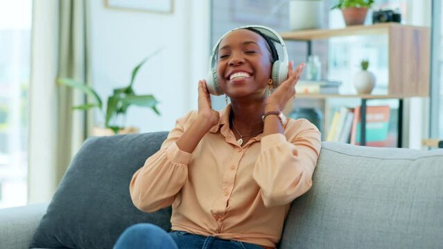 Black Woman, Headphones Or Dancing On Home Sofa To Fun, Carefree Or Freedom Audio In Relax Living Room. Smile, Happy Or Dancer Listening To Music, Radio Or Streaming Media Podcast On House Furniture