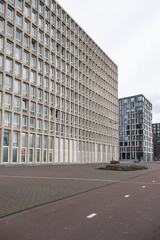 View of high-density residential and business area on the banks of the IJ River at the Oostelijke Handelskade (Eastern Docklands). Amsterdam, The Netherlands. 