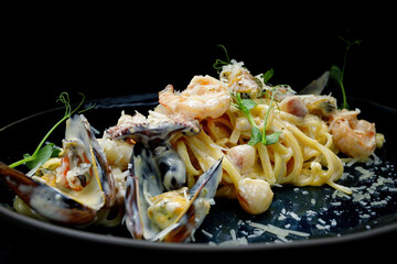 Spaghetti with seafood, mussels, shrimp, octopus, with sauce in a plate