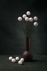 Still life with white balls in a brown vase