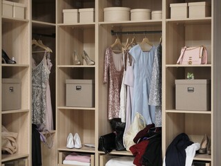 Closet with clothes and accessories in modern dressing room, closeup