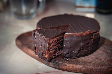 Round chocolate cake with triangular slice cut off
