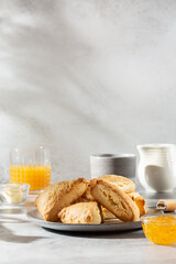 Traditional British scones served with orange jam on gray background. Copy space.
