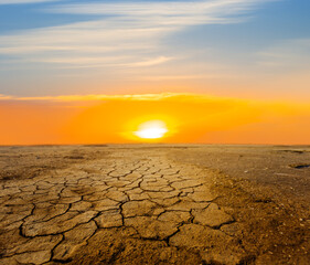 dry cracked earth at the dramatic sunset