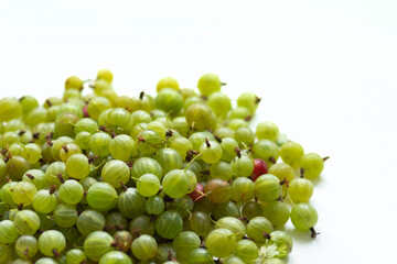 Hill of green gooseberries on a whiute background
