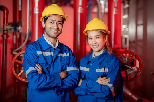 Team Asian engineer man and woman of mechanical plumbing and sanitary system. Worker has proudly his job. Worker has proudly his job. Concept Engineer Operating and control in Factory with safety.