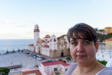 Fototapeta na wymiar Portrait of a young female tourist against a clear sky in Spain