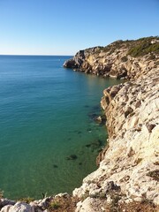 Fototapeta premium Rocky beach, coastline with turquoise sea, hiking in Sitges, Spain