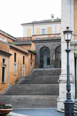 Stairs in Rome with ochre walls on the building, Steps near piazza Campidoglio