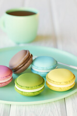 Realistic food. Coffee cup and plate with colorful macaroons. Soft focus. 3D render