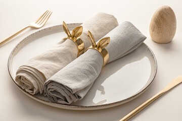 Easter table setting with linen napkins and golden cutlery