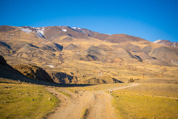 Road in Kyzyl-Chin valley or Mars valley with mountain background in Altai, Siberia, Russia.