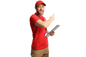 Cheerful male shop assistant holding a clipboard and pointing behind