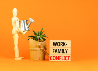 Work-family conflict symbol. Concept words Work-family conflict on wooden block on a beautiful...